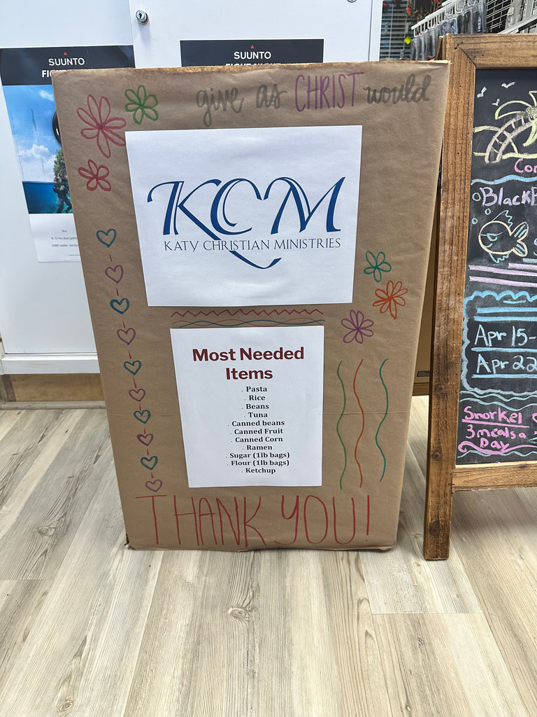 KCM Food Bank Donation - Outside The Asylum Diving & Travel